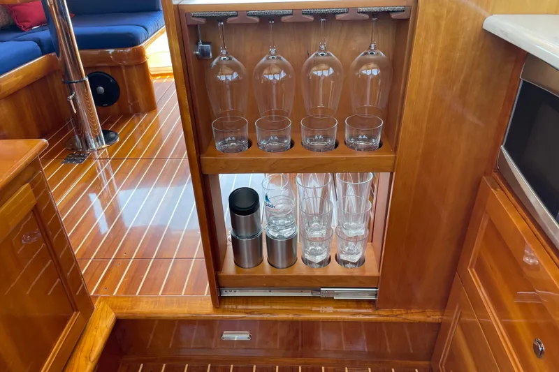 Slide: The Image of Luxurious interior of 2017 Hinckley Talaria 43 Motoryacht with elegant glassware storage. - 25