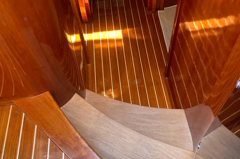 Slide: The Image of Interior of 2017 Hinckley Talaria 43 Motoryacht with elegant wooden flooring and curved staircase. - 29