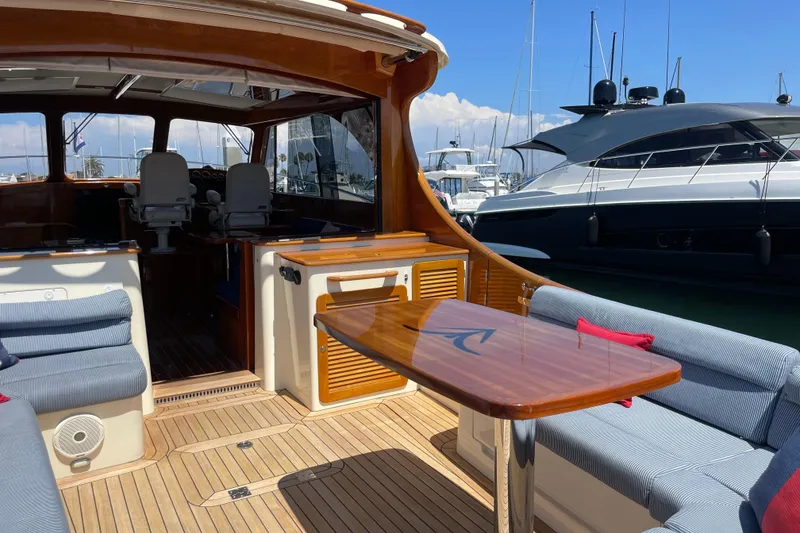 Slide: The Image of 2017 Hinckley Talaria 43 Motoryacht interior with elegant seating and wooden table. - 3