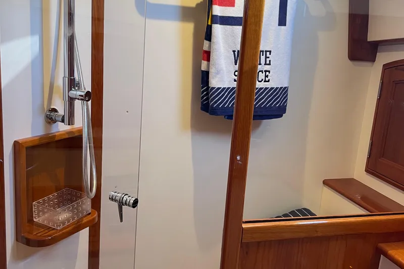 Slide: The Image of Hinckley Talaria 43 Motoryacht 2017 bathroom with shower and nautical-themed towel. - 34