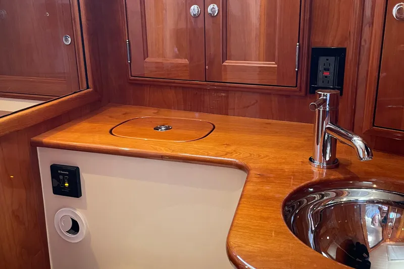 Slide: The Image of Luxurious wooden interior of 2017 Hinckley Talaria 43 Motoryacht bathroom with sink and faucet. - 37