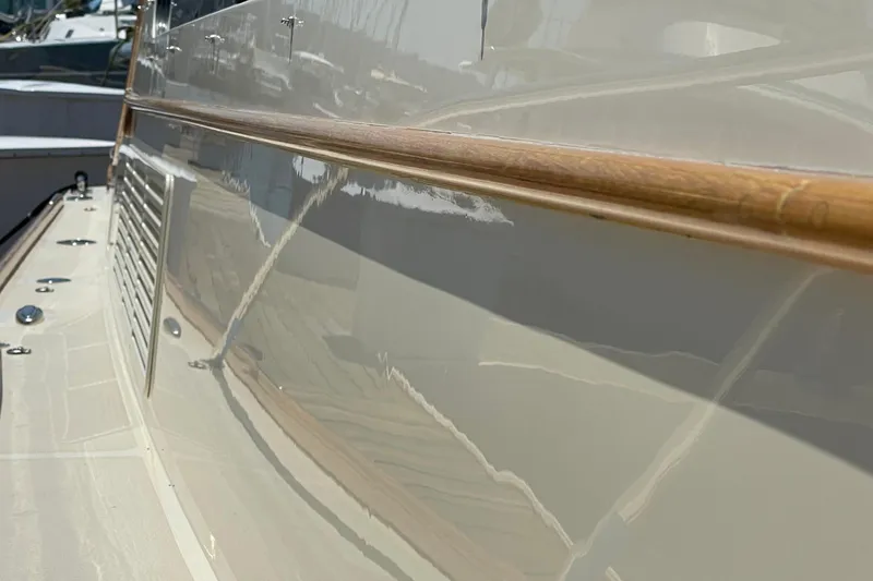 Slide: The Image of 2017 Hinckley Talaria 43 Motoryacht, sleek side view with polished wood detail. - 45
