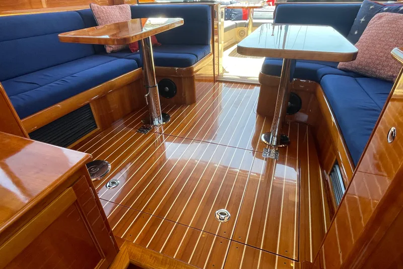 Slide: The Image of Luxurious interior of 2017 Hinckley Talaria 43 Motoryacht with polished wood and blue seating. - 8