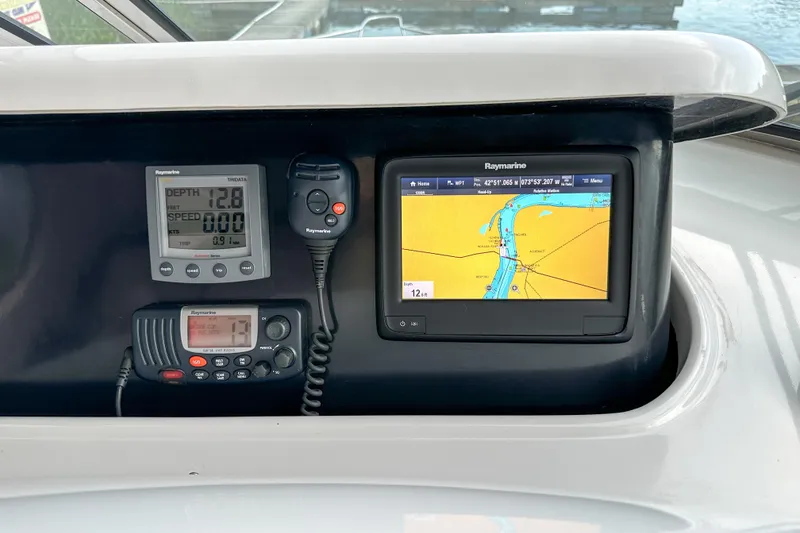 Slide: The Image of Boat navigation system on 2012 Bluewater 5200, featuring Raymarine displays and controls. - 10