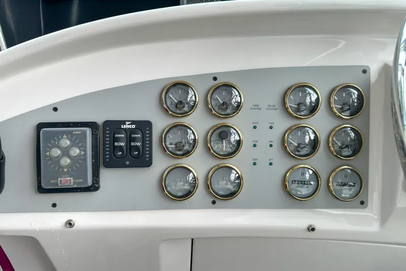 Slide: The Image of Control panel of a 2012 Bluewater 5200 boat with gauges and switches. - 11