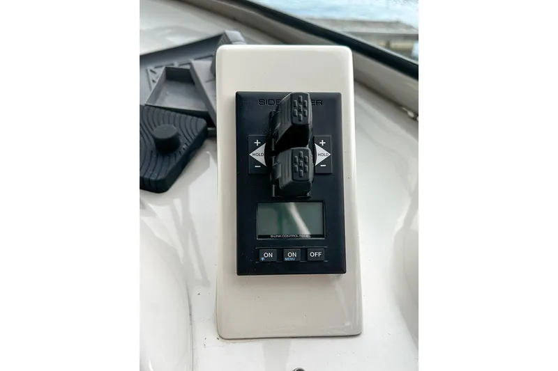 Slide: The Image of Control panel of a 2012 Bluewater 5200 boat with digital display and switches. - 14