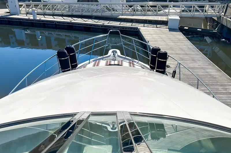 Slide: The Image of 2012 Bluewater 5200 yacht docked at marina, view from bow. - 16