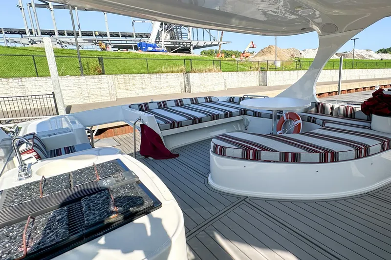 Slide: The Image of Luxurious 2012 Bluewater 5200 yacht deck with striped seating and modern amenities. - 18
