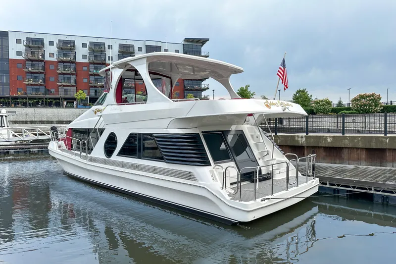 Slide: The Image of Luxury 2012 Bluewater 5200 yacht docked in a marina with modern buildings. - 2