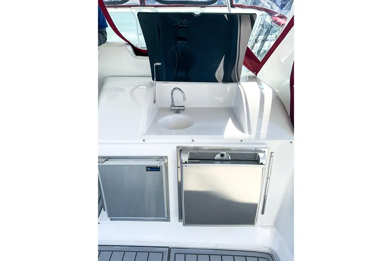Slide: The Image of 2012 Bluewater 5200 yacht kitchenette with sink, faucet, and stainless steel appliances. - 22