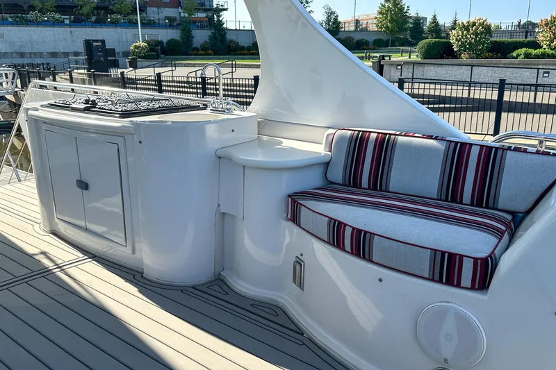 Slide: The Image of Luxury Bluewater 5200 yacht deck with striped seating and outdoor kitchen, 2012 model. - 23