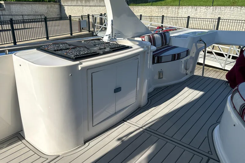 Slide: The Image of Luxurious 2012 Bluewater 5200 Custom Series Yacht deck with seating and grill area. - 24