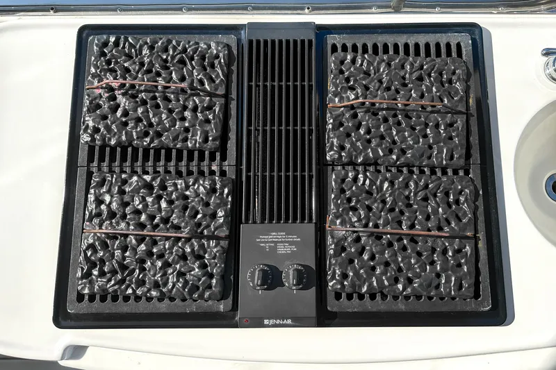 Slide: The Image of Outdoor grill on 2012 Bluewater 5200 Custom Series Yacht, featuring a Jenn-Air cooktop. - 26