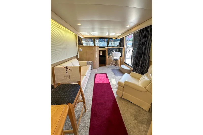 Slide: The Image of Luxurious interior of 2012 Bluewater 5200 Custom Series Yacht with elegant seating and helm. - 29