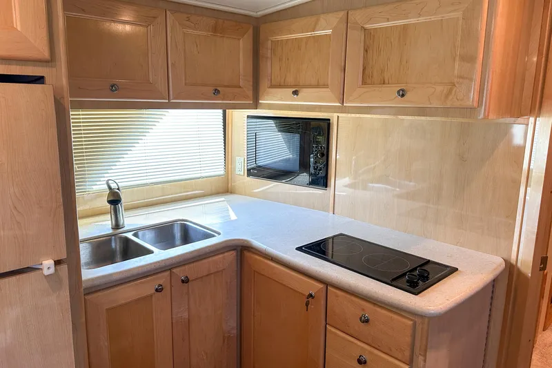 Slide: The Image of Modern kitchen in 2012 Bluewater 5200 Custom Series Yacht with wood cabinets and dual sink. - 32