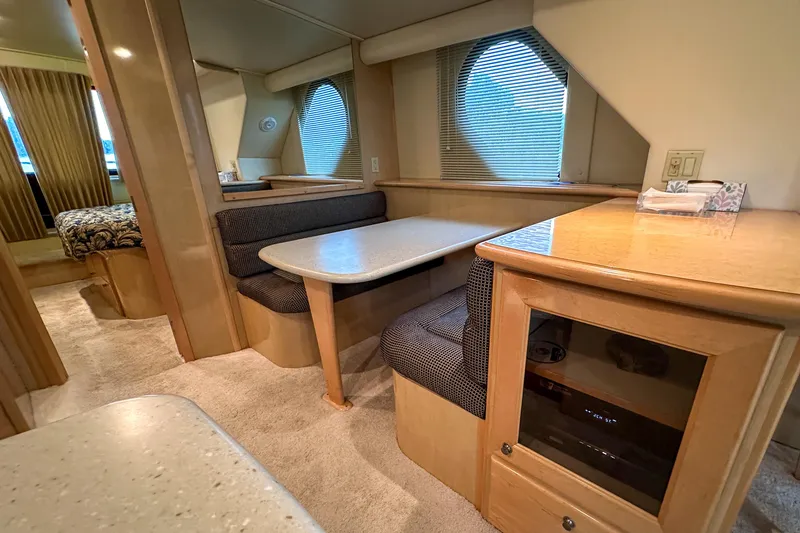 Slide: The Image of Interior of 2012 Bluewater 5200 Custom Series Yacht with cozy dining area and modern furnishings. - 34