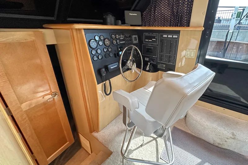 Slide: The Image of Interior helm of 2012 Bluewater 5200 Custom Series Yacht with control panel and captain's chair. - 40