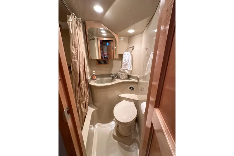 Slide: The Image of Bathroom interior of 2012 Bluewater 5200 Custom Series Yacht, featuring modern fixtures and compact design. - 41
