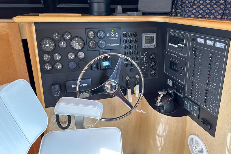 Slide: The Image of Cockpit of 2012 Bluewater 5200 Custom Series Yacht with steering wheel and control panel. - 43