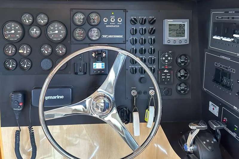 Slide: The Image of Control panel of 2012 Bluewater 5200 Custom Series Yacht with steering wheel and gauges. - 44