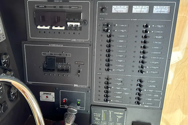 Slide: The Image of Control panel of a 2012 Bluewater 5200 Custom Series Yacht, featuring various switches and gauges. - 45
