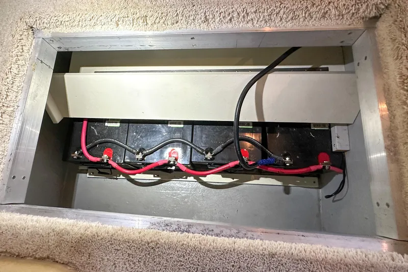 Slide: The Image of Battery compartment of 2012 Bluewater 5200 Custom Series Yacht with connected cables. - 50