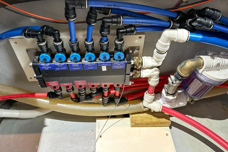 Slide: The Image of Plumbing system of 2012 Bluewater 5200 Custom Series Yacht with labeled valves and pipes. - 52