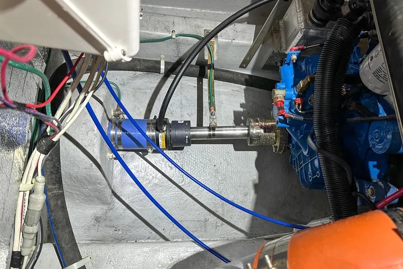 Slide: The Image of Engine compartment of 2012 Bluewater 5200 Custom Series Yacht, showcasing mechanical components and wiring. - 53