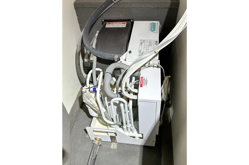 Slide: The Image of Engine compartment of 2012 Bluewater 5200 Custom Series Yacht, showcasing mechanical components. - 54