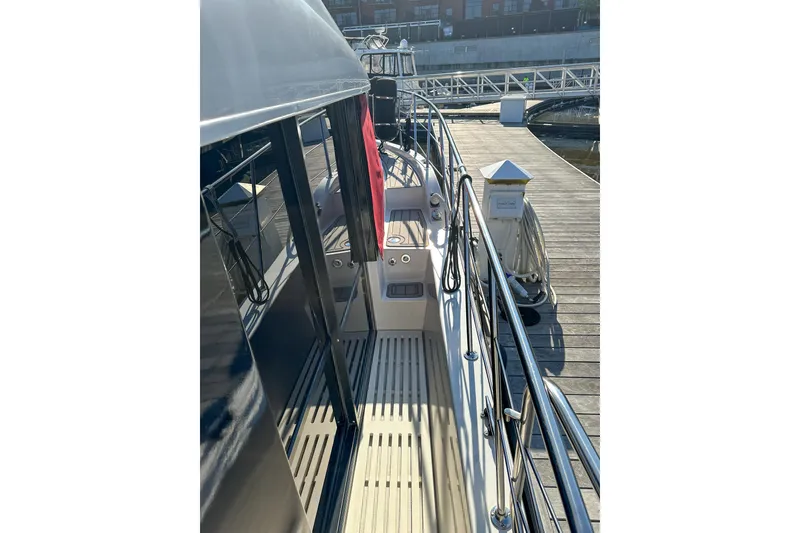 Slide: The Image of 2012 Bluewater 5200 yacht docked at marina, showcasing sleek deck design. - 6