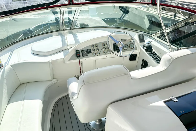 Slide: The Image of Luxurious 2012 Bluewater 5200 yacht cockpit with white seating and modern controls. - 8