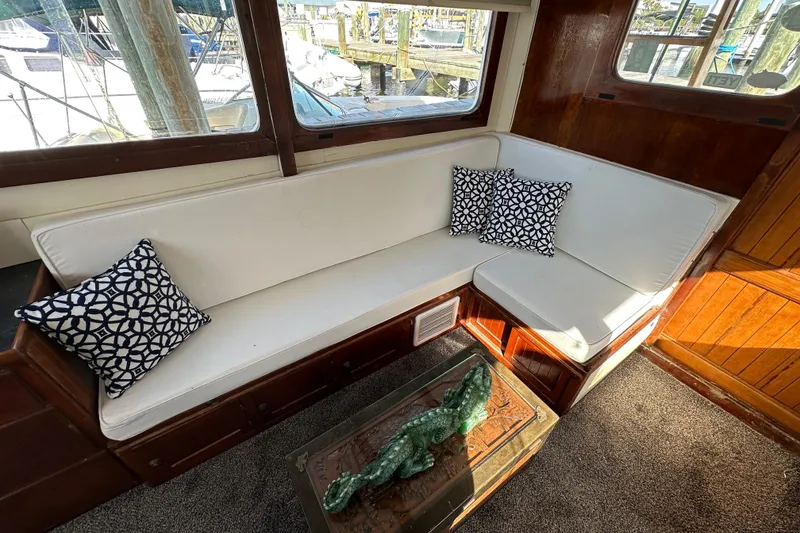 Slide: The Image of Cozy interior of 1973 CHB 34 boat with white seating and decorative pillows. - 19