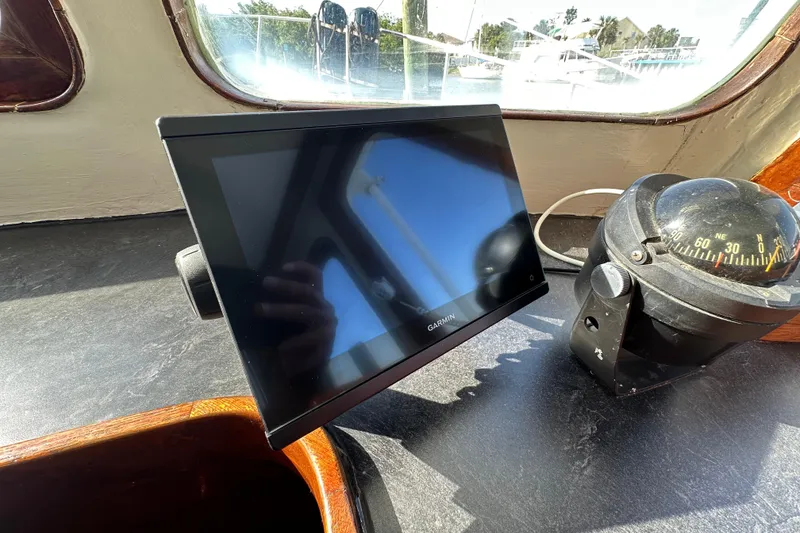 Slide: The Image of Garmin display and compass on 1973 CHB 34 boat dashboard. - 25