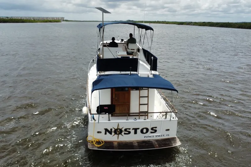 Slide: The Image of 1973 CHB 34 boat cruising on a river under cloudy skies. - 3