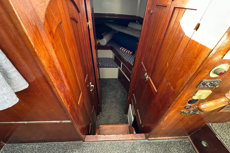 Slide: The Image of Interior of a 1973 CHB 34 boat with wooden paneling and cozy sleeping area. - 30