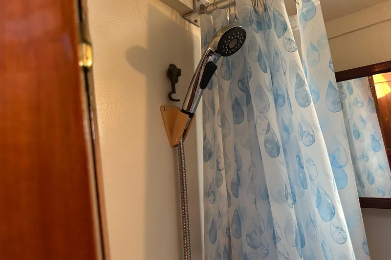 Slide: The Image of Shower area in a 1973 CHB 34 boat with blue raindrop curtain. - 33
