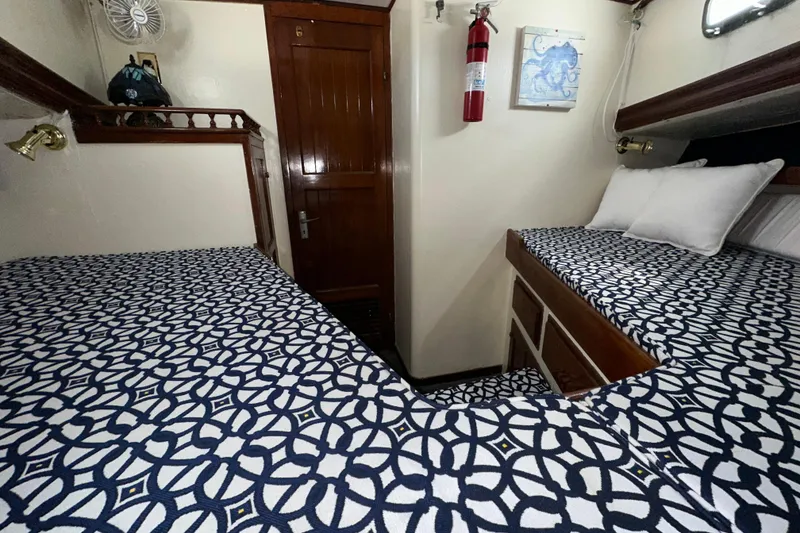 Slide: The Image of Cozy cabin interior of a 1973 CHB 34 boat with patterned bedding and wooden accents. - 37