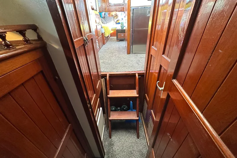 Slide: The Image of Interior of a 1973 CHB 34 boat with wooden paneling and carpeted flooring. - 38