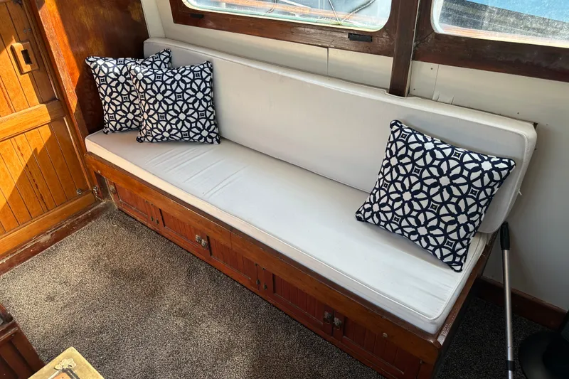 Slide: The Image of Interior of 1973 CHB 34 boat with white sofa and patterned cushions. - 18