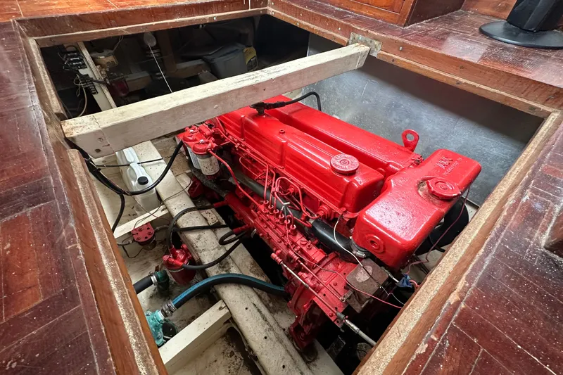 Slide: The Image of Red engine inside a 1973 CHB 34 boat, surrounded by wooden flooring. - 40