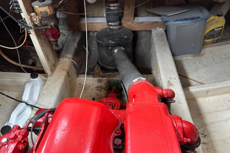Slide: The Image of Engine compartment of a 1973 CHB 34 boat with red engine components and wiring. - 45