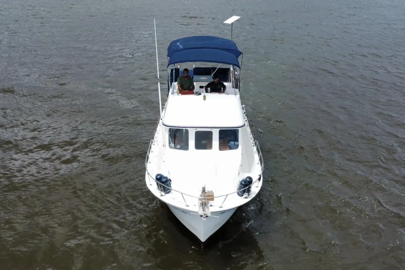 Slide: The Image of 1973 CHB 34 boat cruising on open water with two people onboard. - 7