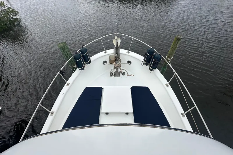 Slide: The Image of Bow view of 1973 CHB 34 boat with blue cushions and mooring posts. - 9