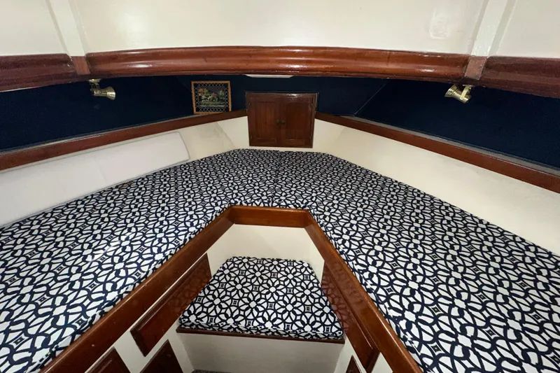 Slide: The Image of V-berth cabin interior of 1973 CHB 34 boat with patterned cushions and wooden trim. - 35