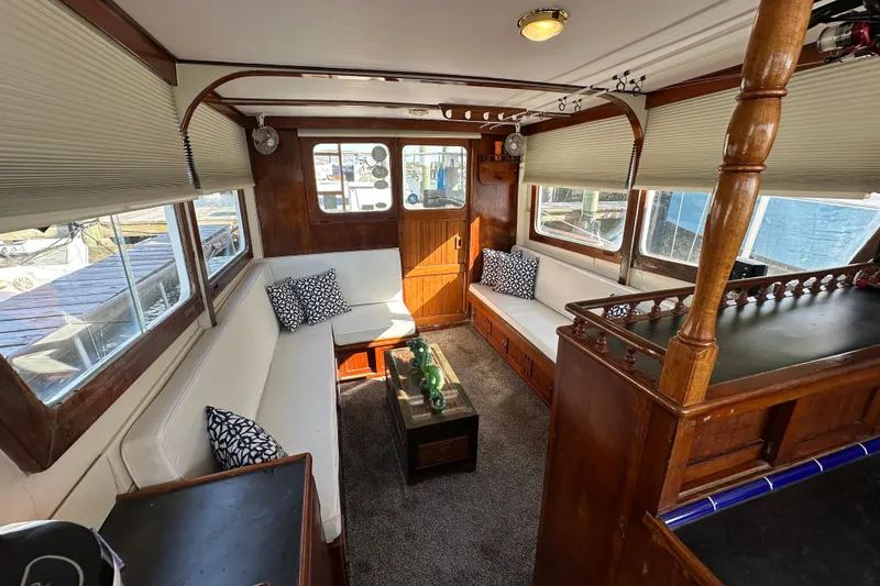 Slide: The Image of Interior of a 1973 CHB 34 boat with cozy seating and wooden accents. - 39