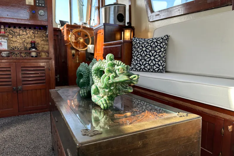 Slide: The Image of Vintage 1973 CHB 34 boat interior with jade dragon sculpture and nautical decor. - 21