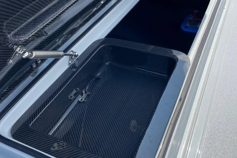 Slide: The Image of 2025 Chittum Skiffs Challenger 18 boat interior with speckled flooring, under a clear blue sky. - 10