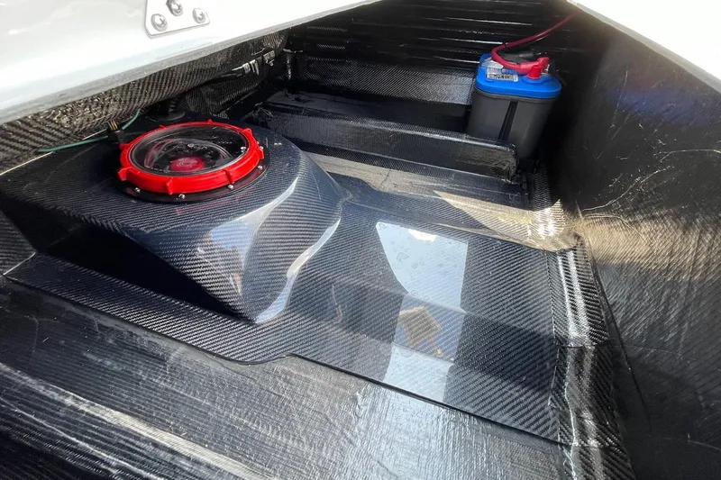 Slide: The Image of 2025 Chittum Skiffs Challenger 18 storage compartment with carbon fiber finish. - 11