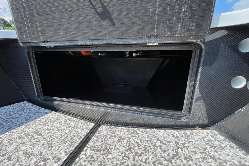 Slide: The Image of Interior of 2025 Chittum Skiffs Challenger 18, featuring carbon fiber and battery compartment. - 12