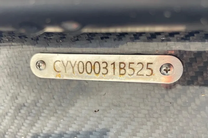 Slide: The Image of Open storage compartment in 2025 Chittum Skiffs Challenger 18 boat, featuring carbon fiber finish. - 13